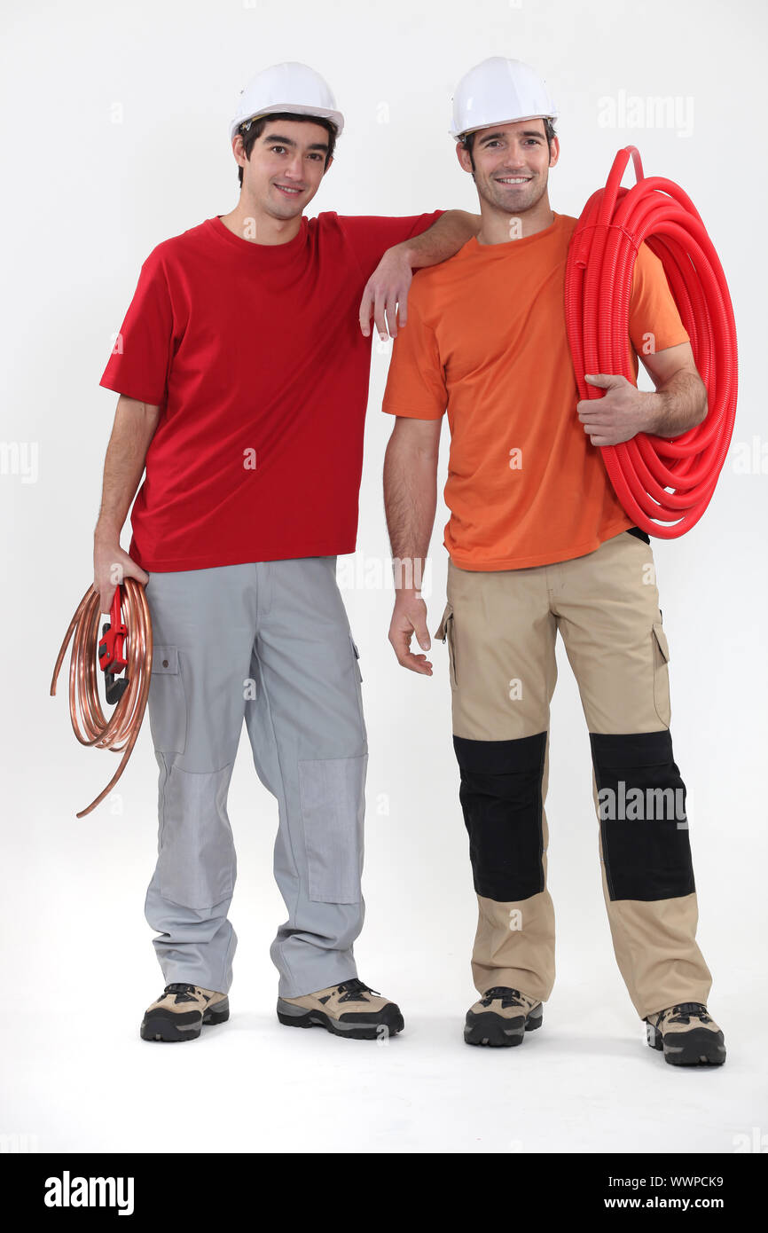 Two plumbers on white background Stock Photo