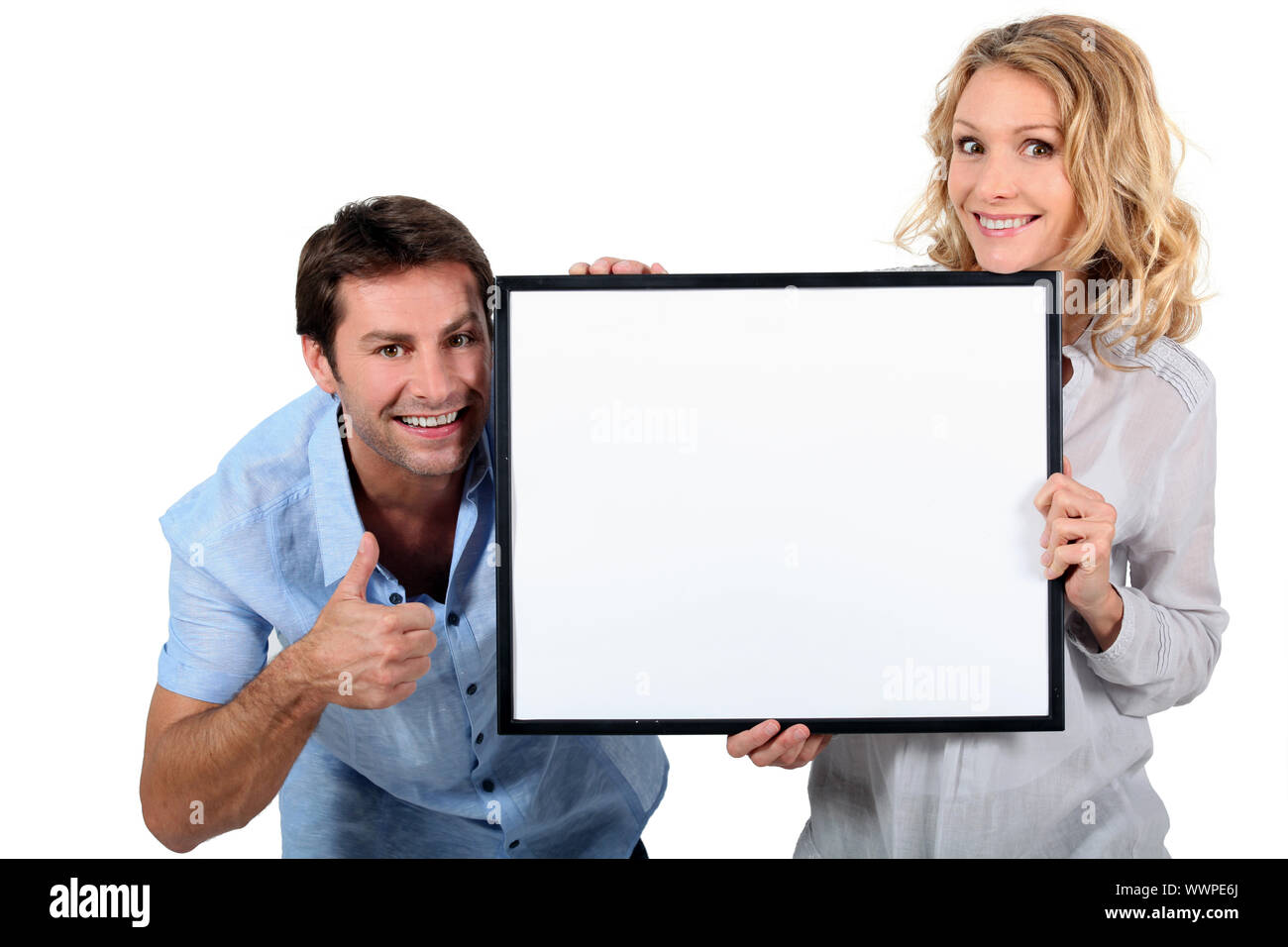 Couple holding up blank sign hi-res stock photography and images - Alamy