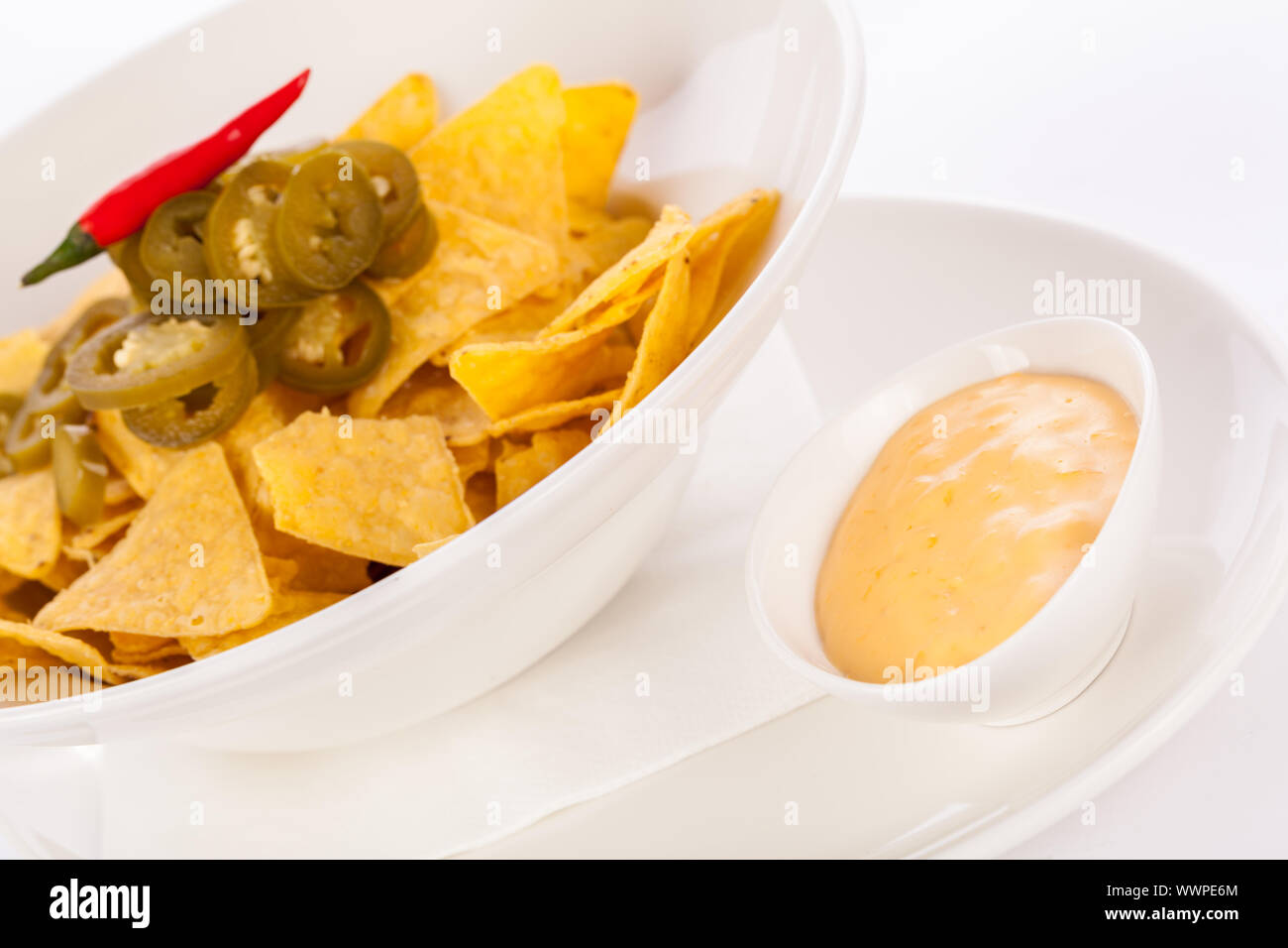 Nachos with cheese sauce and chilli pepperoni Stock Photo