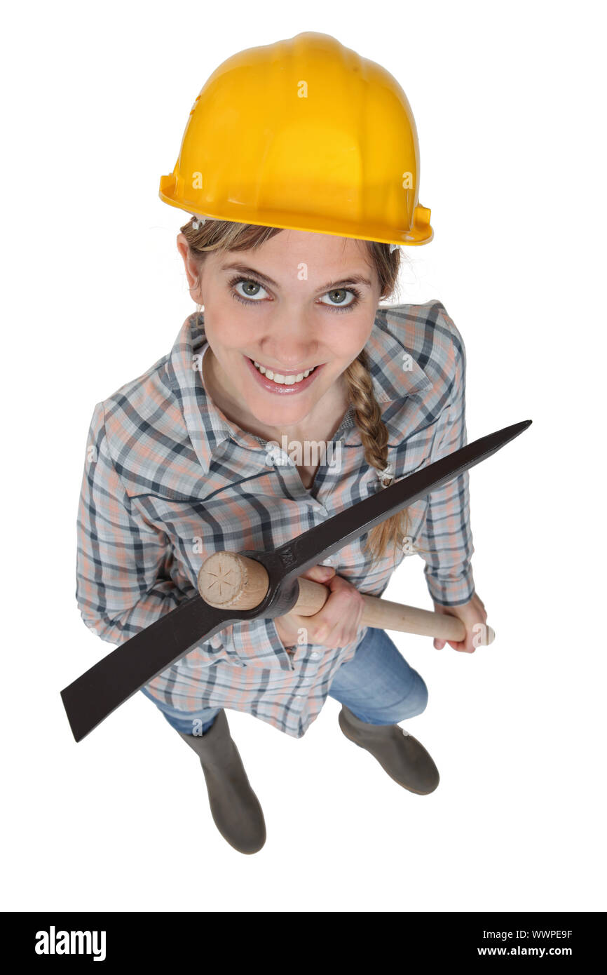 Young female laborer holding a pickaxe Stock Photo