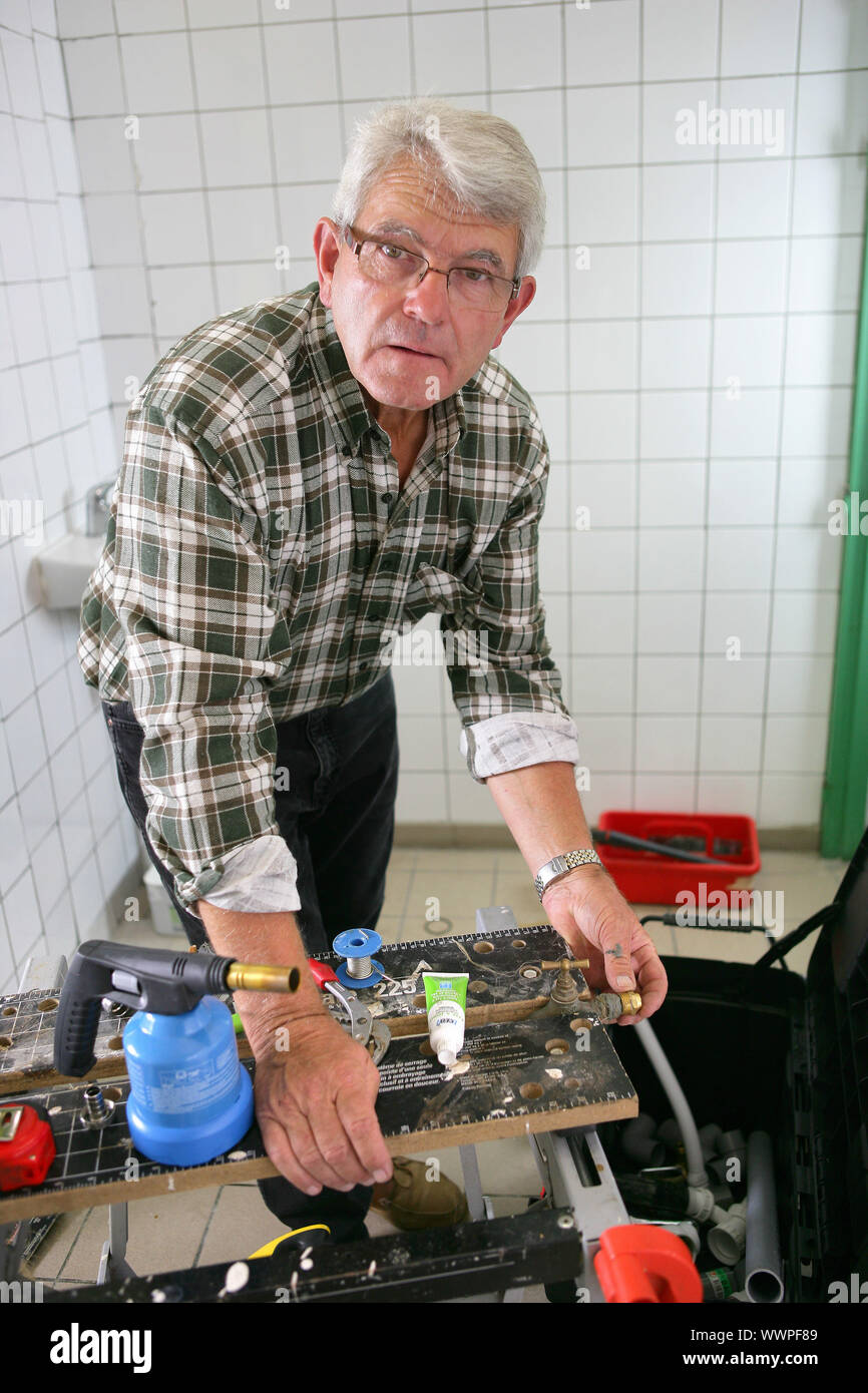 Plumber working in a shower room Stock Photo - Alamy