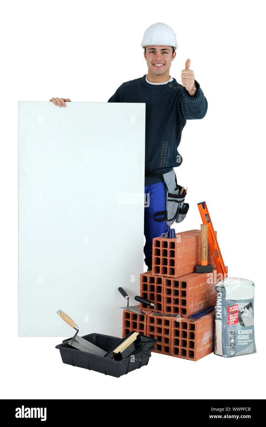 Thumbs up from a builder with a blank board Stock Photo