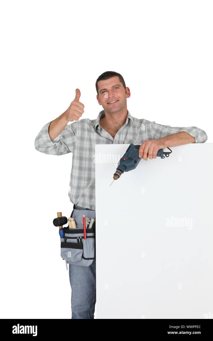 Thumbs up from a builder with a blank board Stock Photo