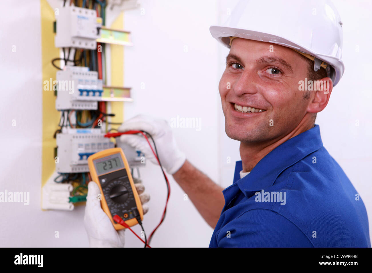 Electrician checking a fuse box Stock Photo Alamy