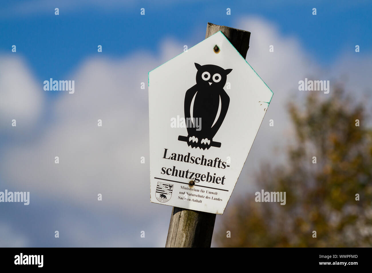 Marking of landscape conservation area in Saxony Anhalt Shield on wooden pile Stock Photo