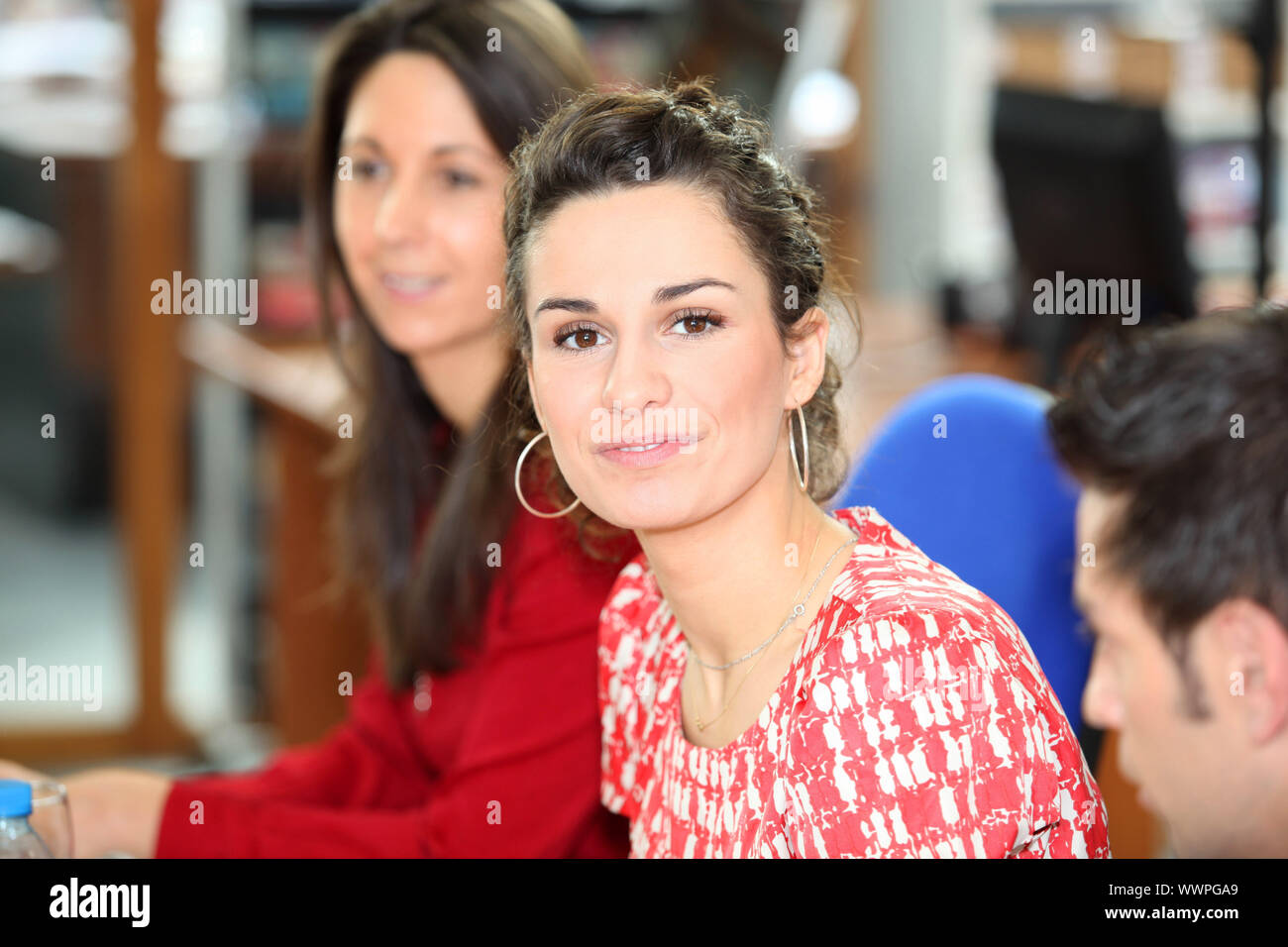 brunette in office with colleagues Stock Photo