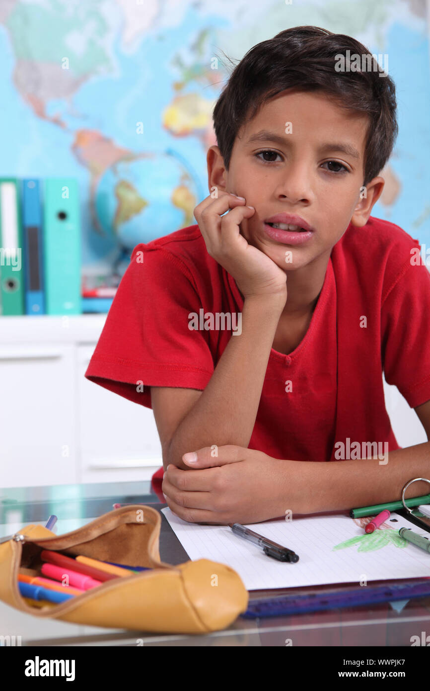 little boy on his school desk Stock Photo Alamy