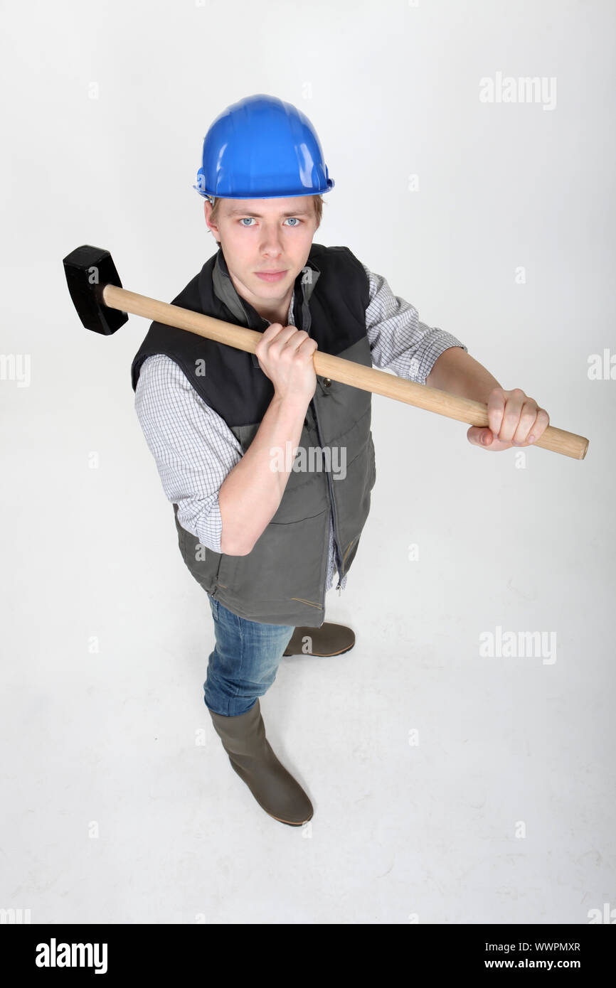 Man wielding heavy hammer Stock Photo Alamy