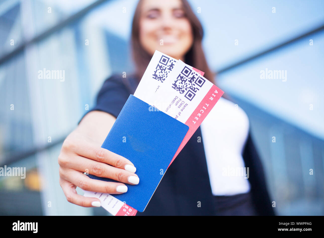 Travel. Woman holding two air ticket in abroad passport near airport ...