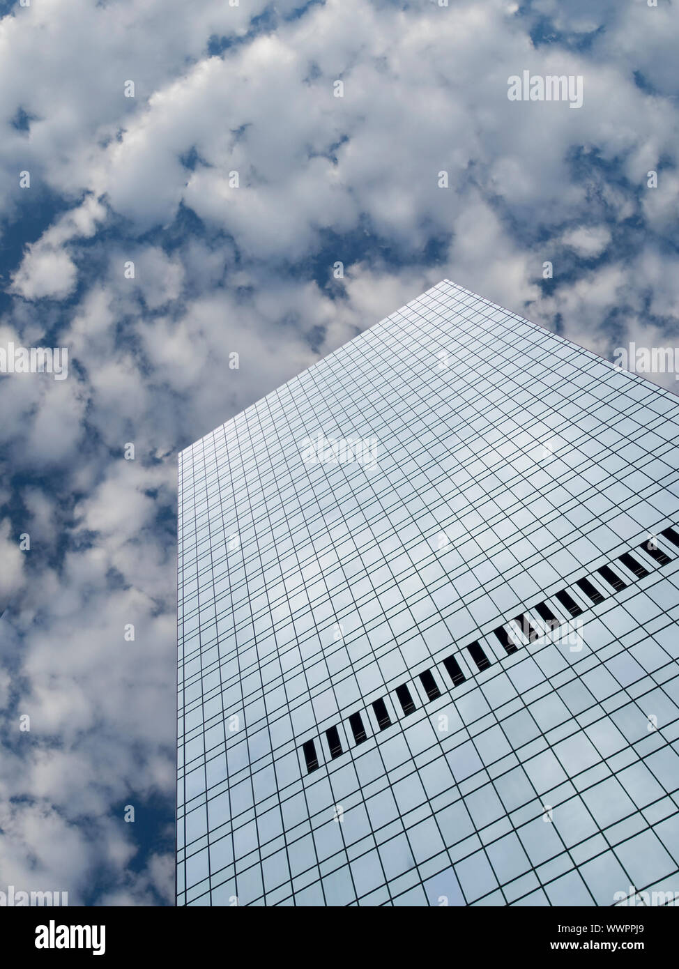 High modern skyscraper on a background of a blue sky and clouds Stock ...