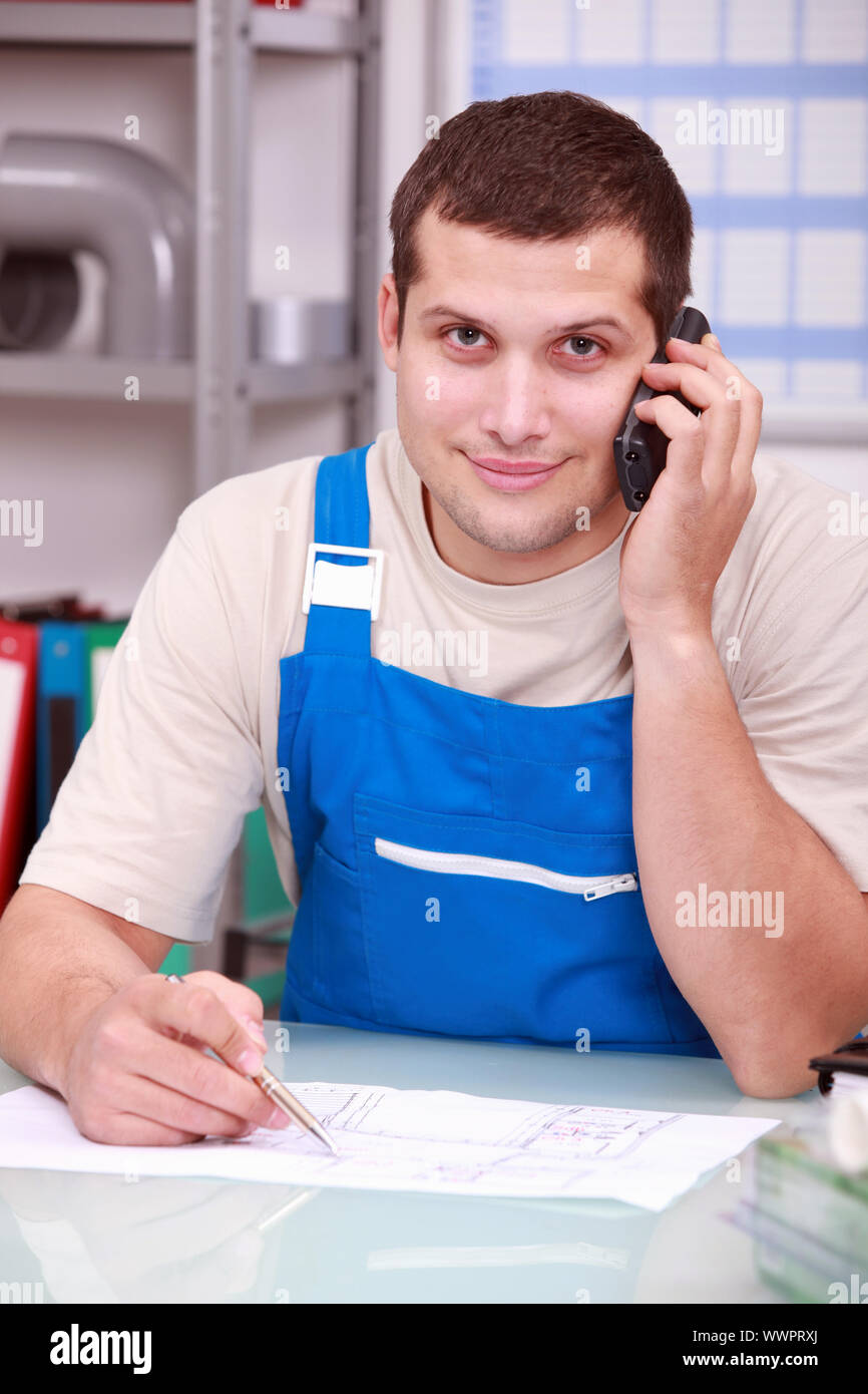 Technician on phone in office Stock Photo
