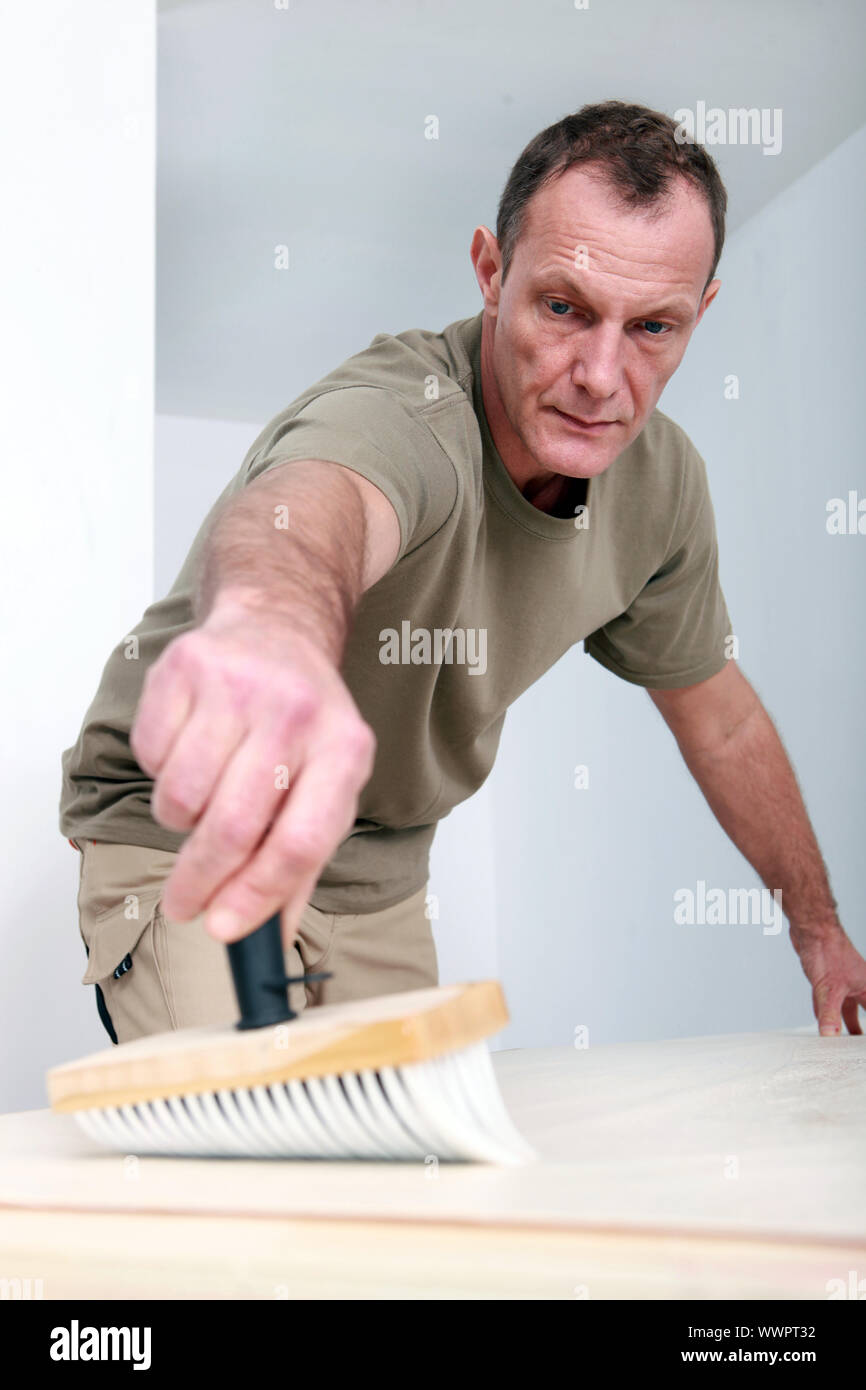 Man applying wallpaper paste Stock Photo Alamy