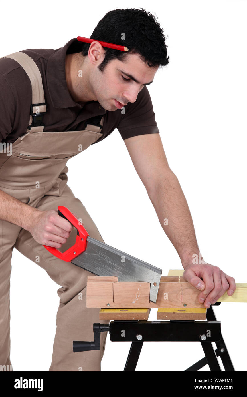 Man cutting a piece of wood Stock Photo