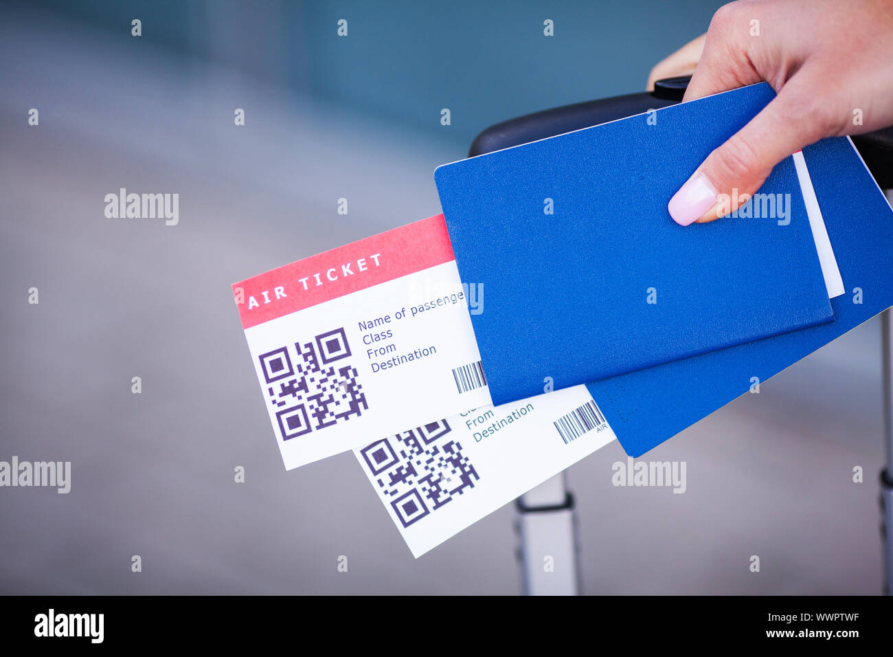 Travel. Woman holding two air ticket in abroad passport near airport ...