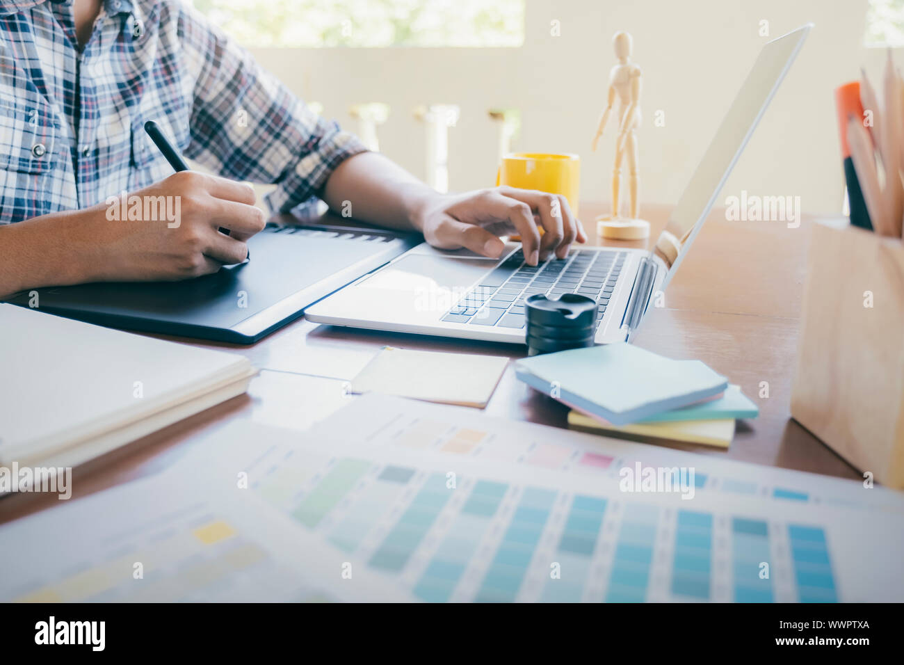 Graphic designer and Photographer working on computer and used graphics ...