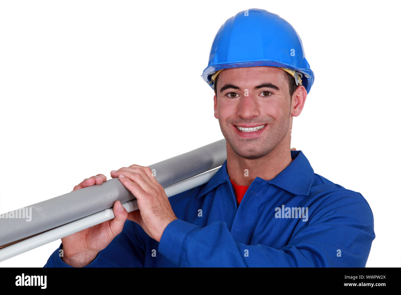 A construction worker carrying a long tube. Stock Photo