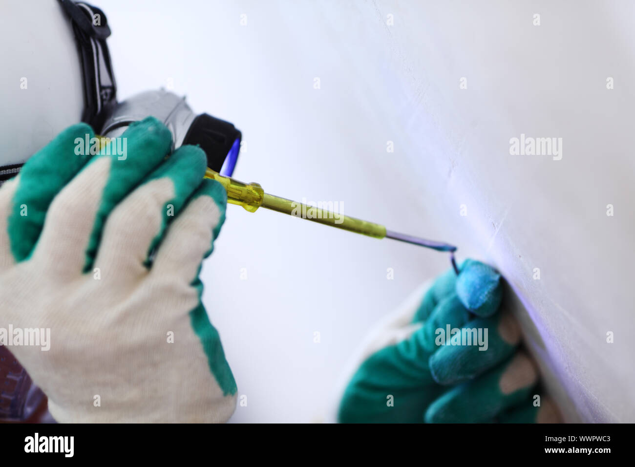 worker puts the wires in the wall Stock Photo Alamy