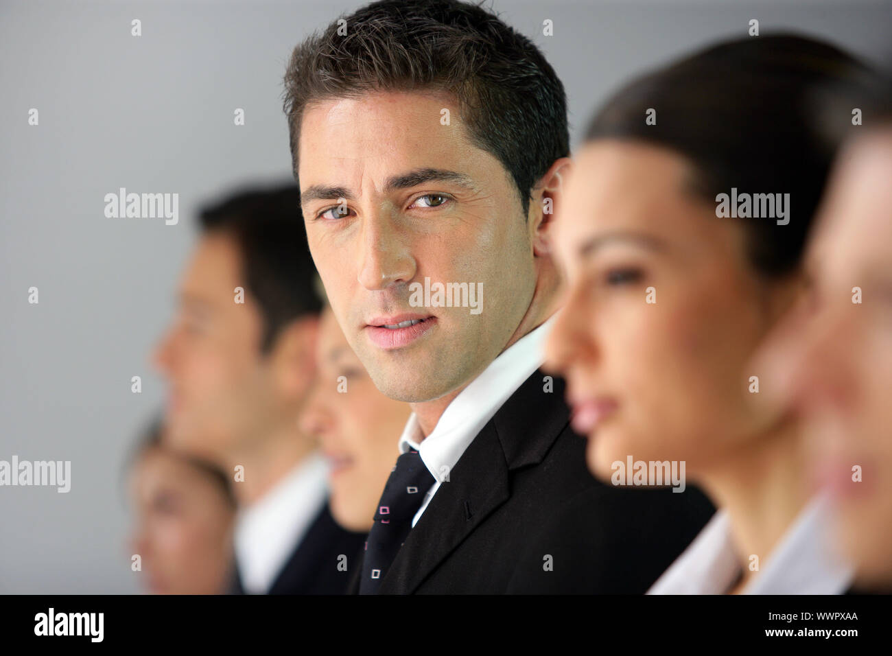 Businesspeople sat in a row Stock Photo