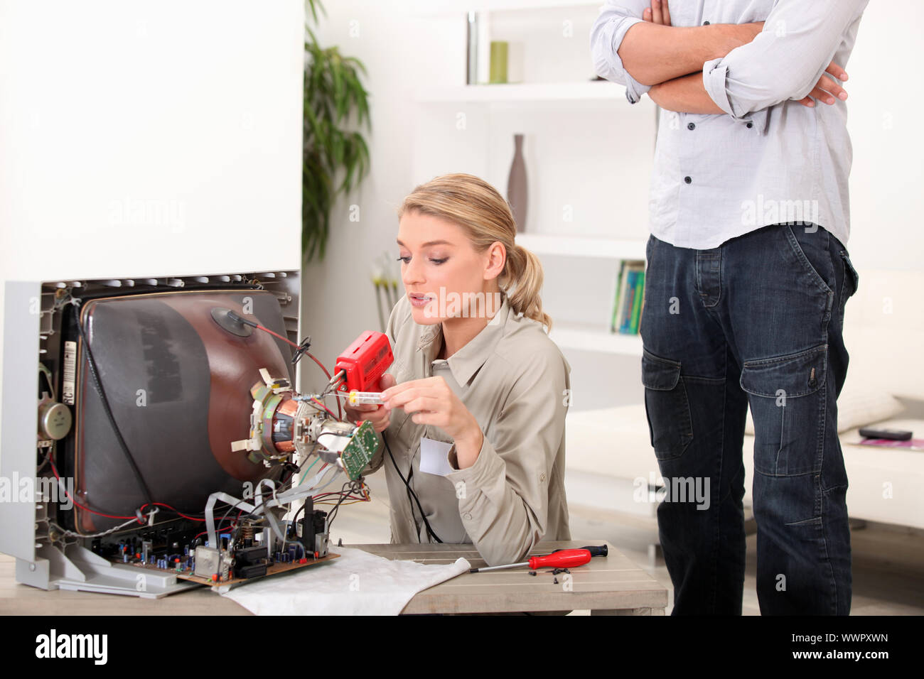 a female technician repairing a television Stock Photo Alamy