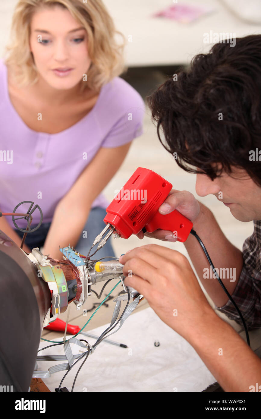 repairman repairing a television Stock Photo Alamy