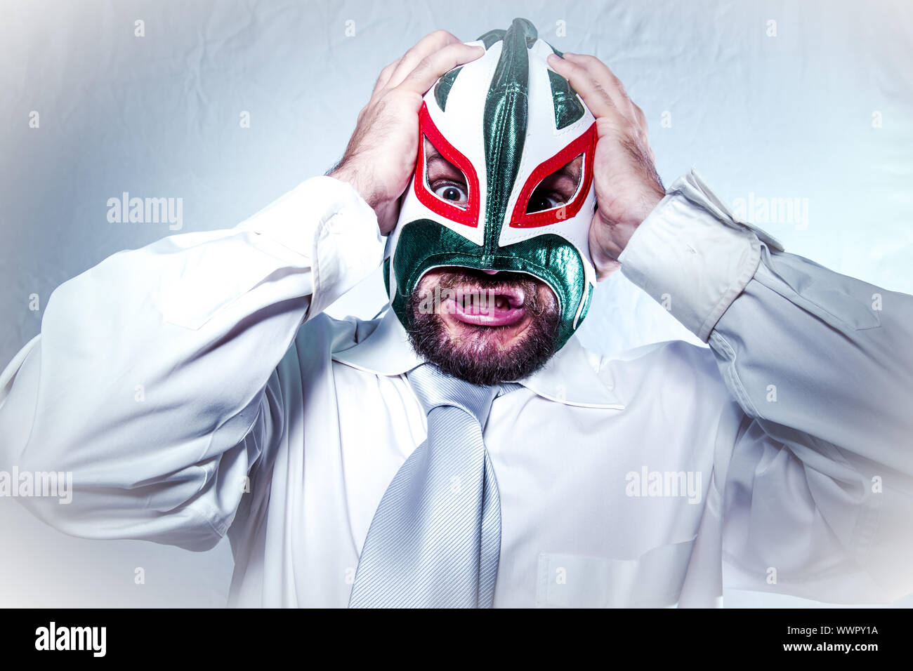 Manager, angry businessman with Mexican wrestler mask, expressions of anger and rage Stock Photo