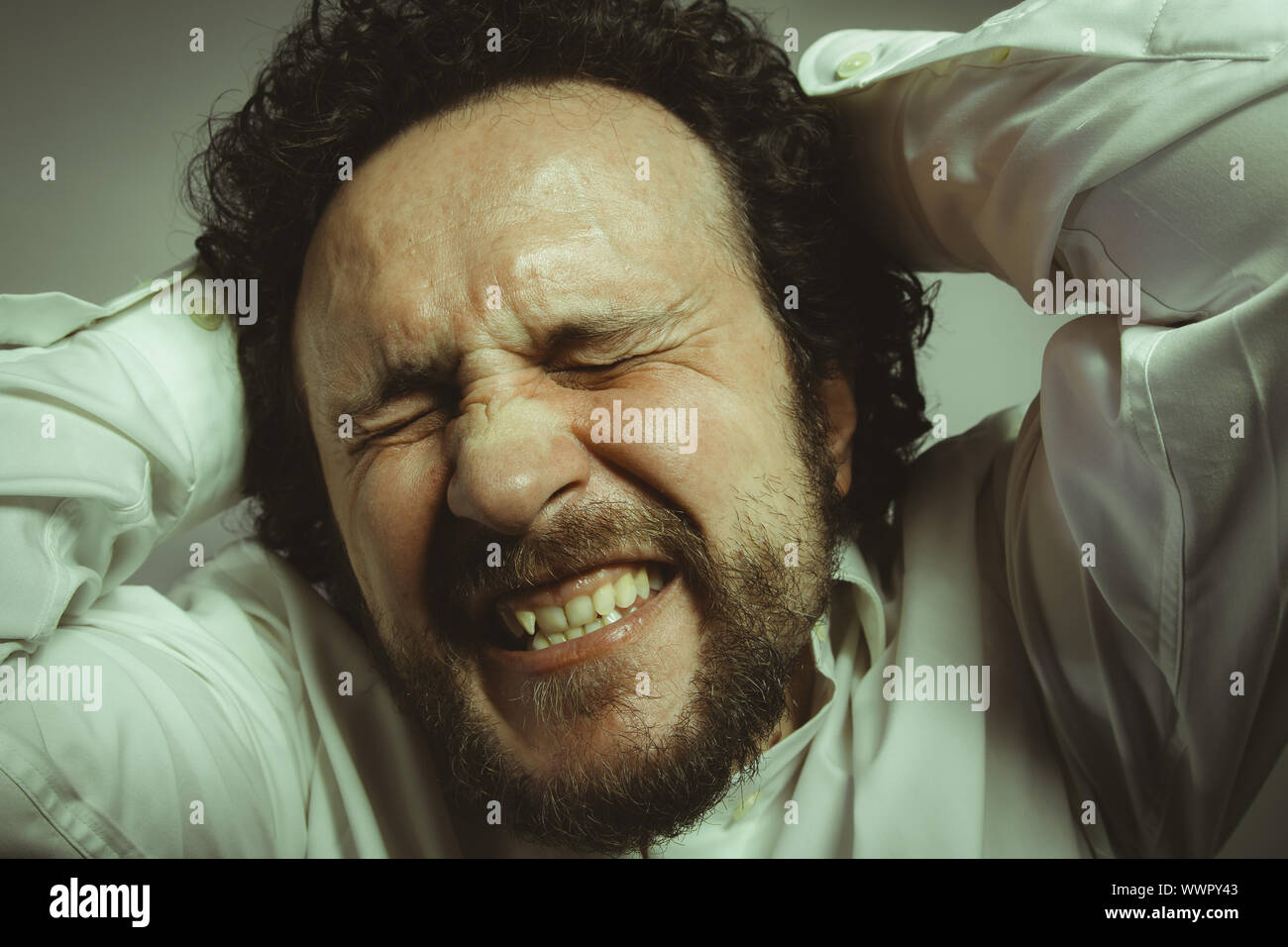 concern for the future, man with intense expression, white shirt Stock Photo