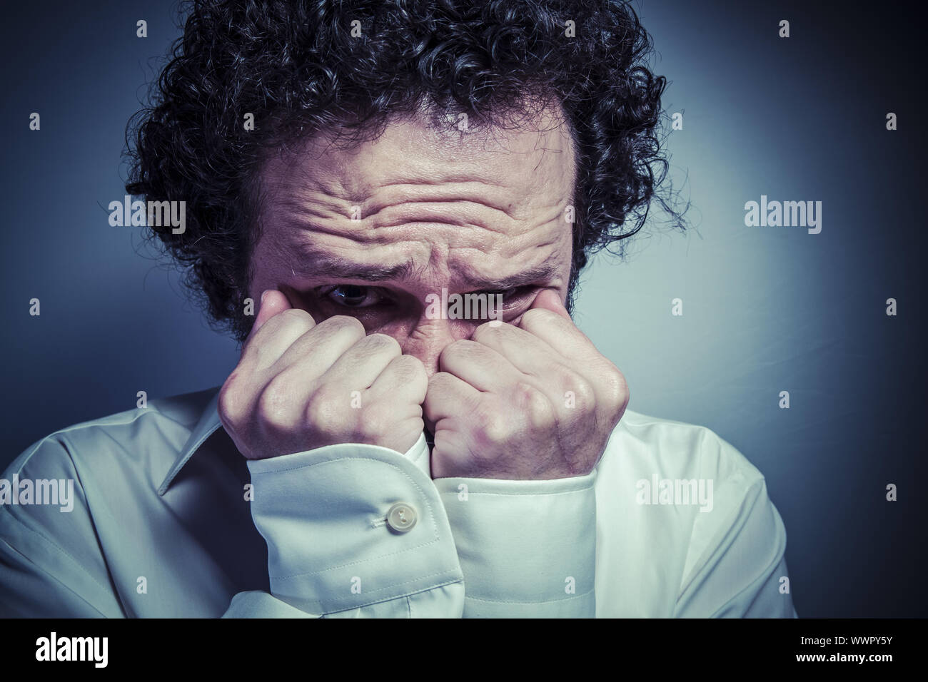 Fear, man with intense expression, white shirt Stock Photo
