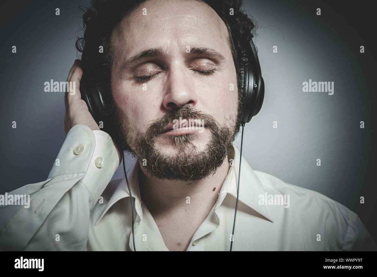 enjoy the music, man with intense expression, white shirt Stock Photo