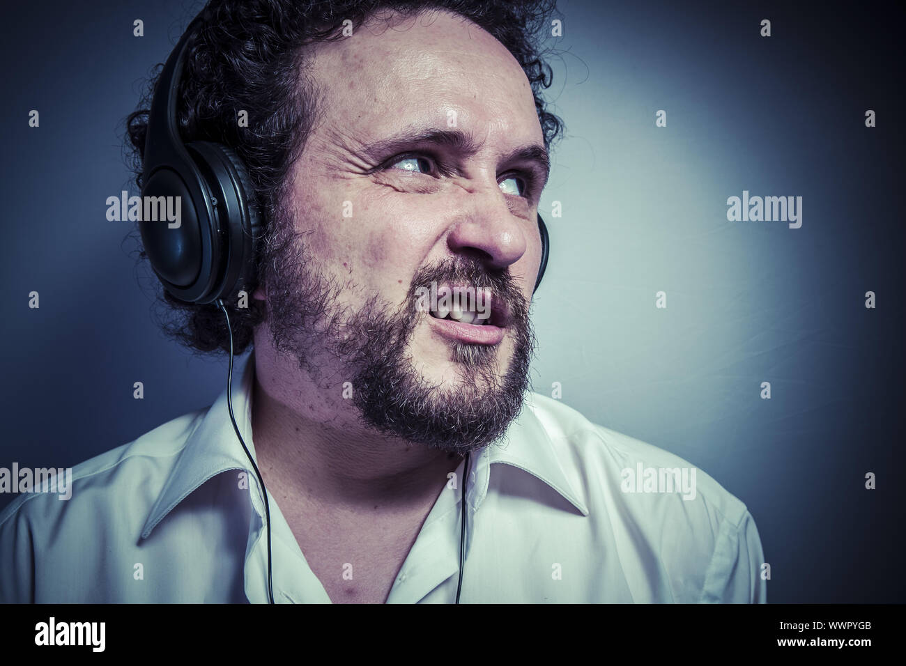 hate music, man with intense expression, white shirt Stock Photo