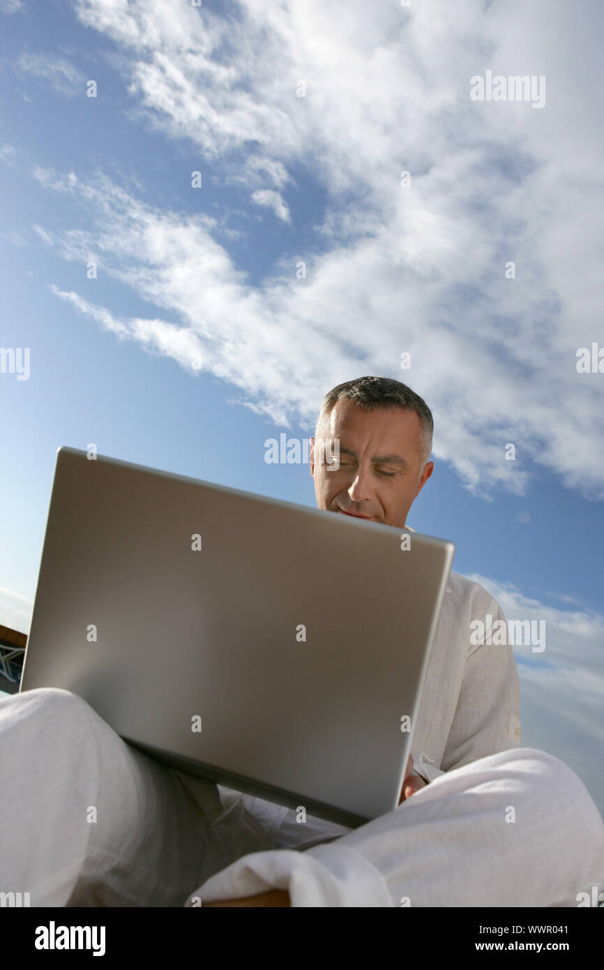 Man with your computer on legs Stock Photo - Alamy
