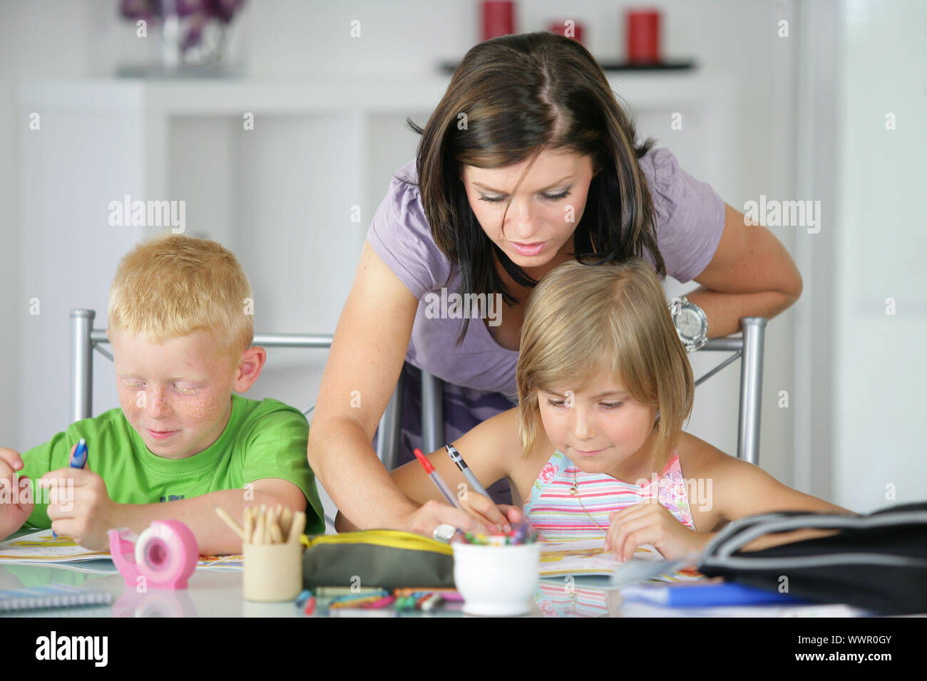 mother helping her kids with the homework Stock Photo - Alamy