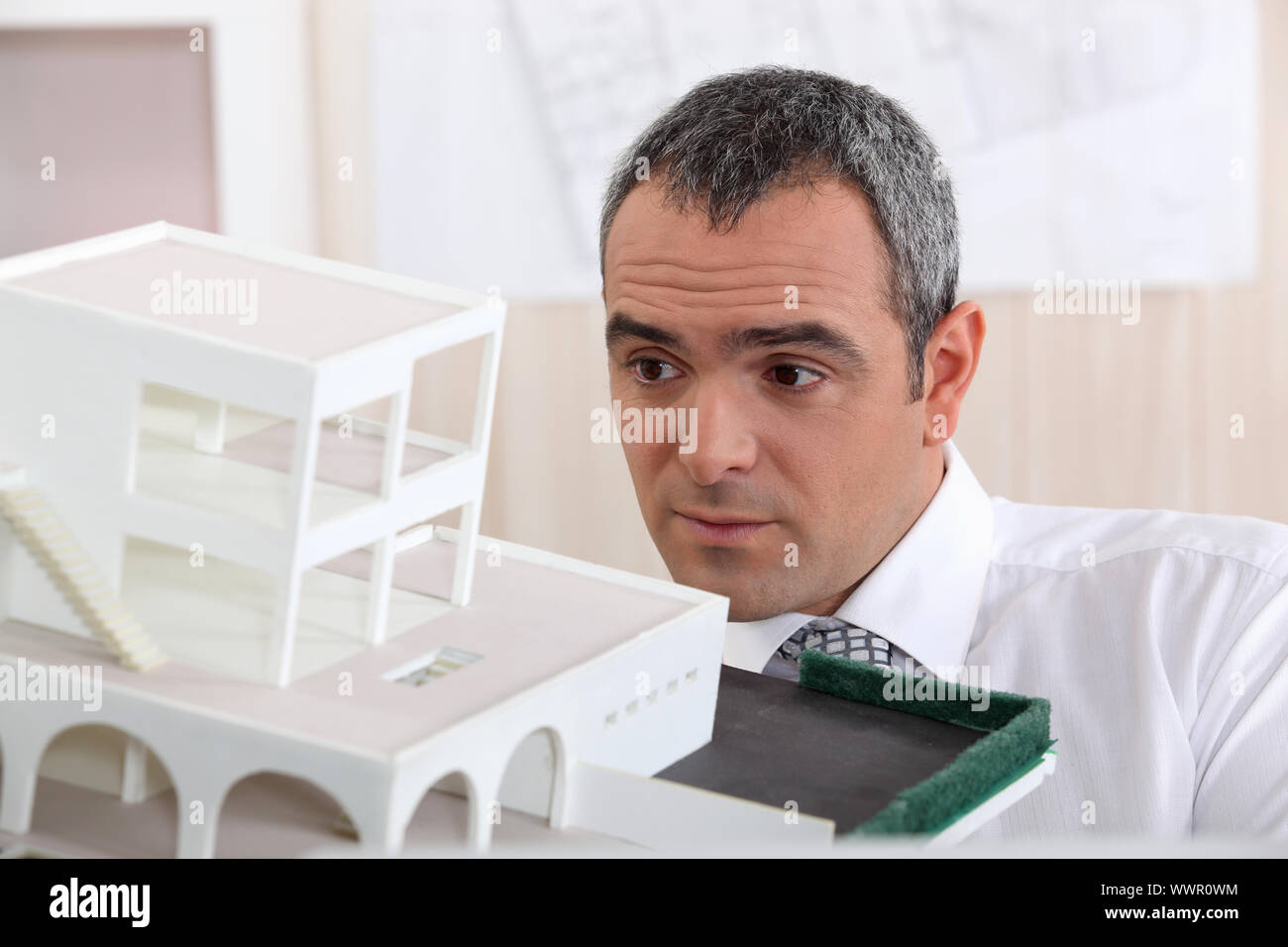 real estate businessman holding an architectural model Stock Photo