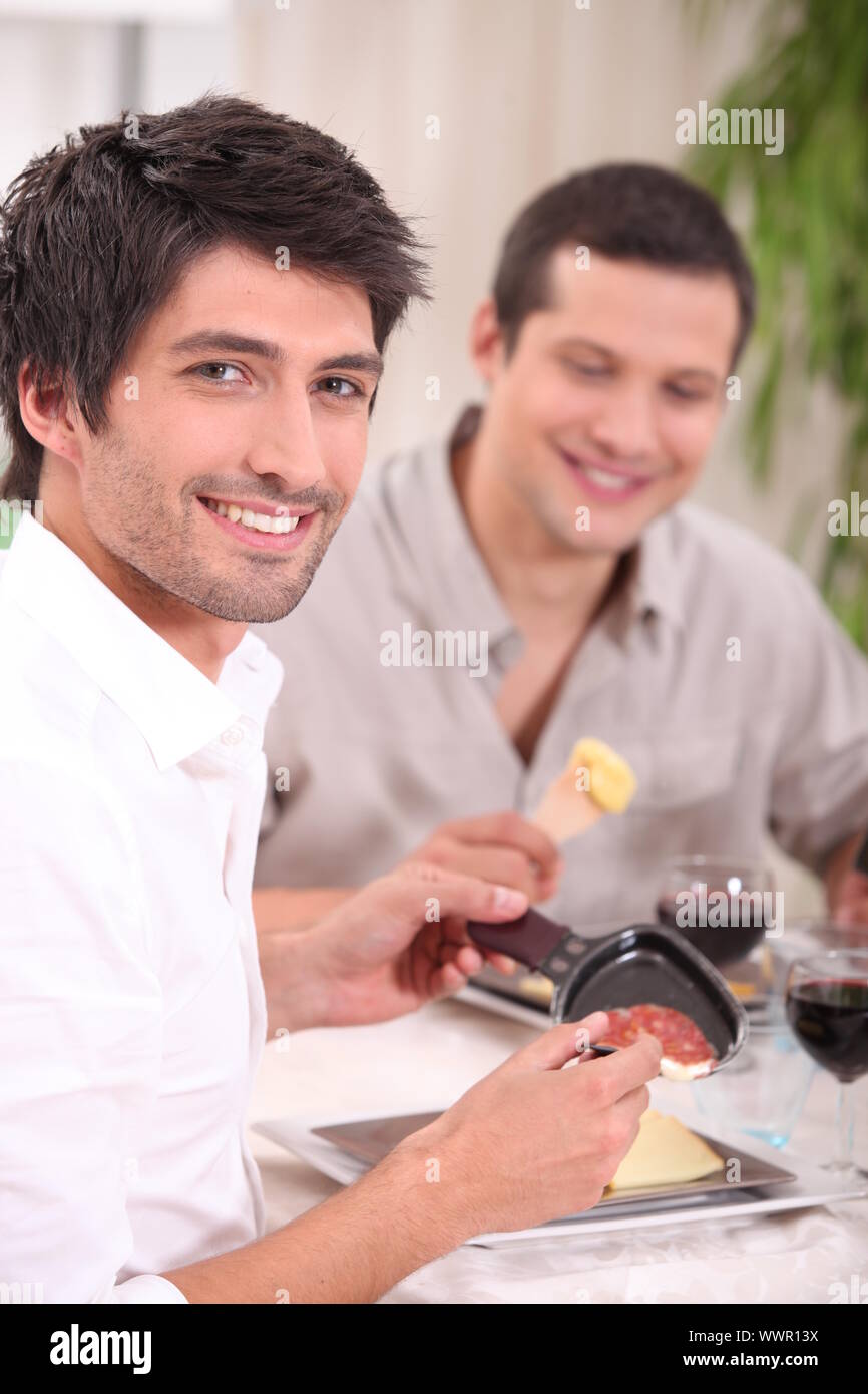 Eating a raclette Stock Photo - Alamy