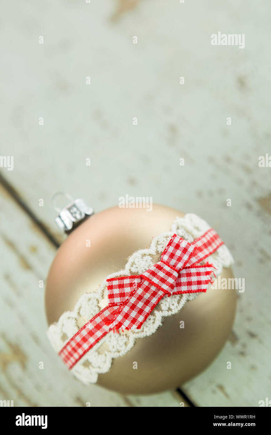 Three Christmas baubles on rustic wood Stock Photo