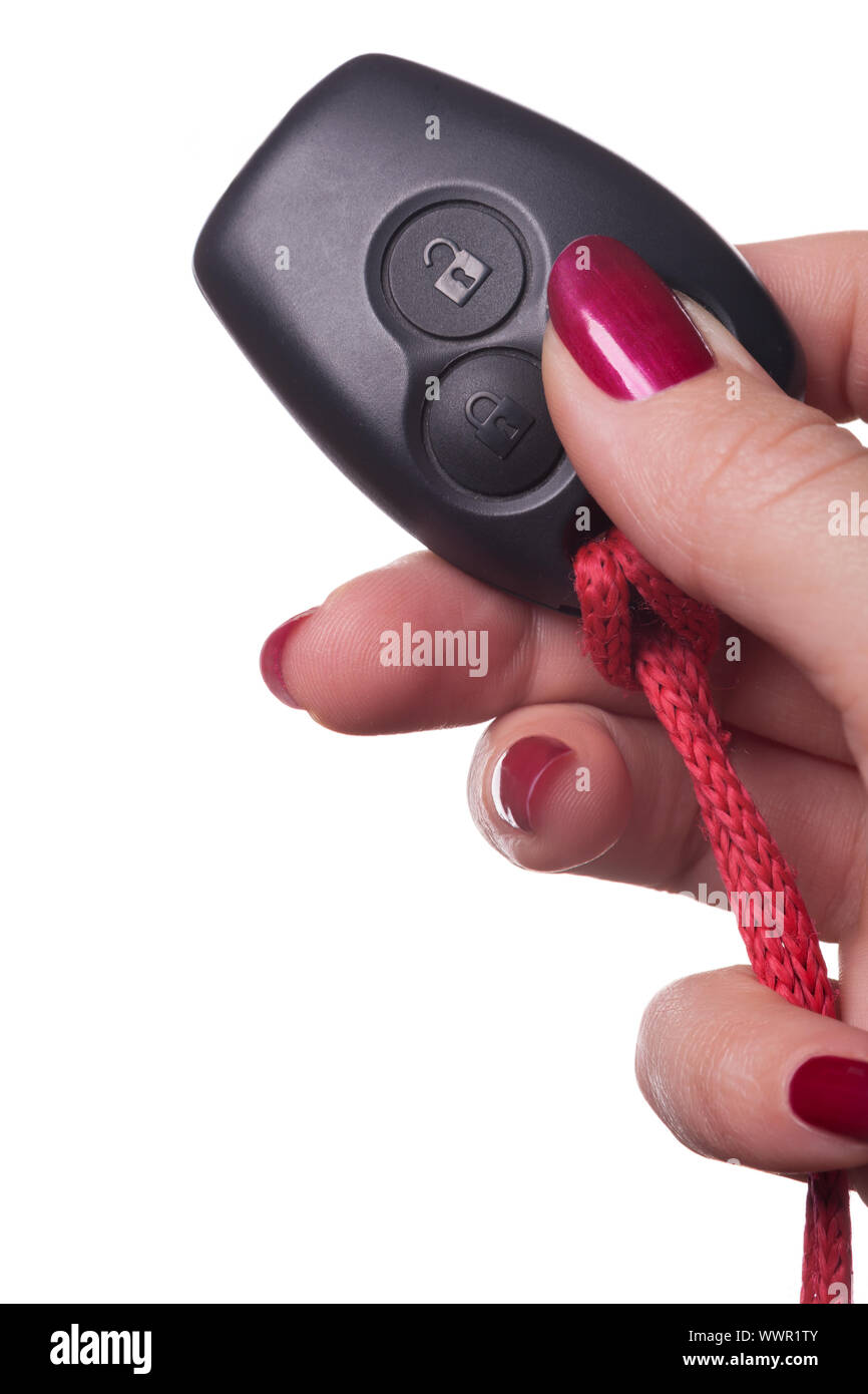 Close up of hand holding car key on white Stock Photo
