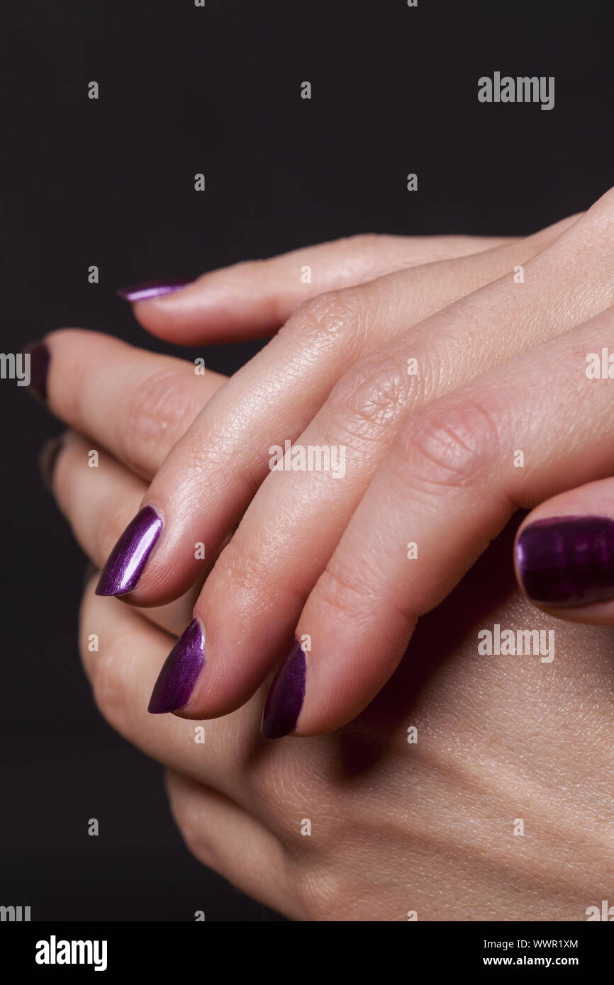 Close up of female hands over black Stock Photo