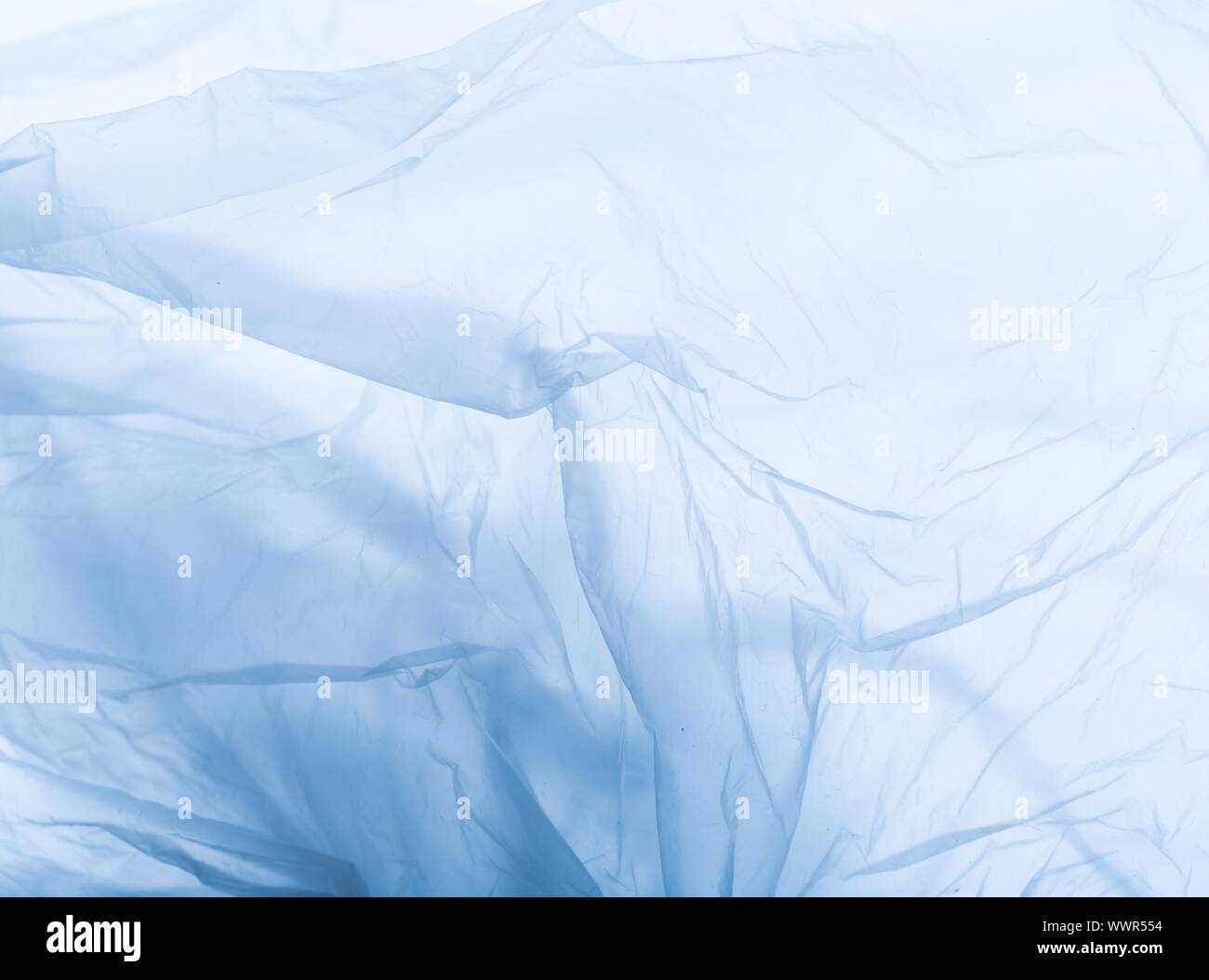 Abstract of plastic foil useful as background. Close up of creased plastic foil bag. Stock Photo