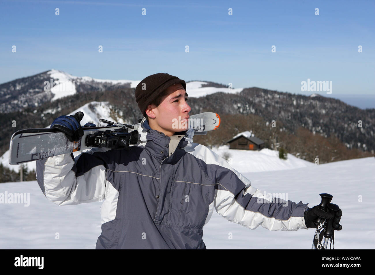Boy with skis on shoulder Stock Photo