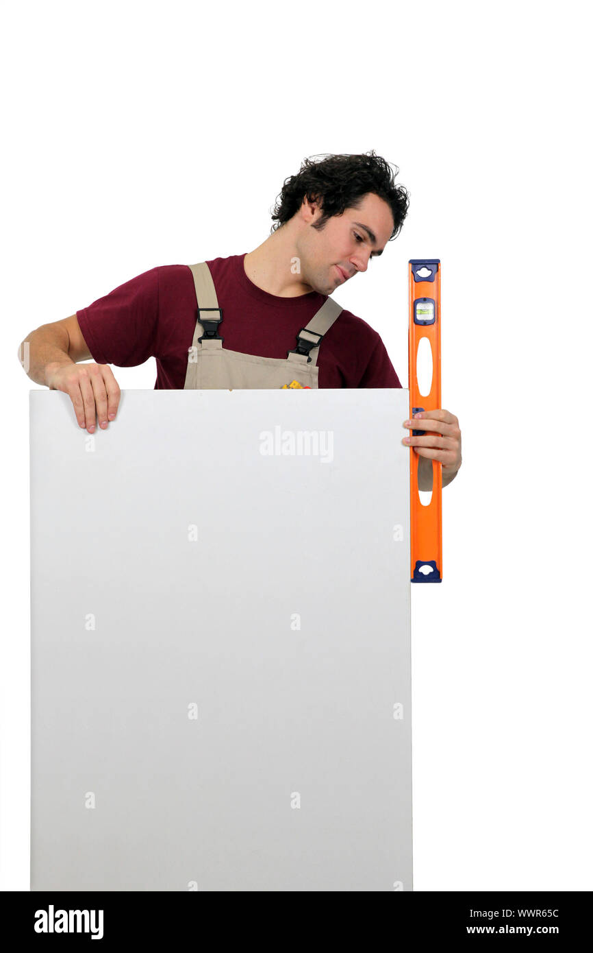 Workman using a spirit level Stock Photo