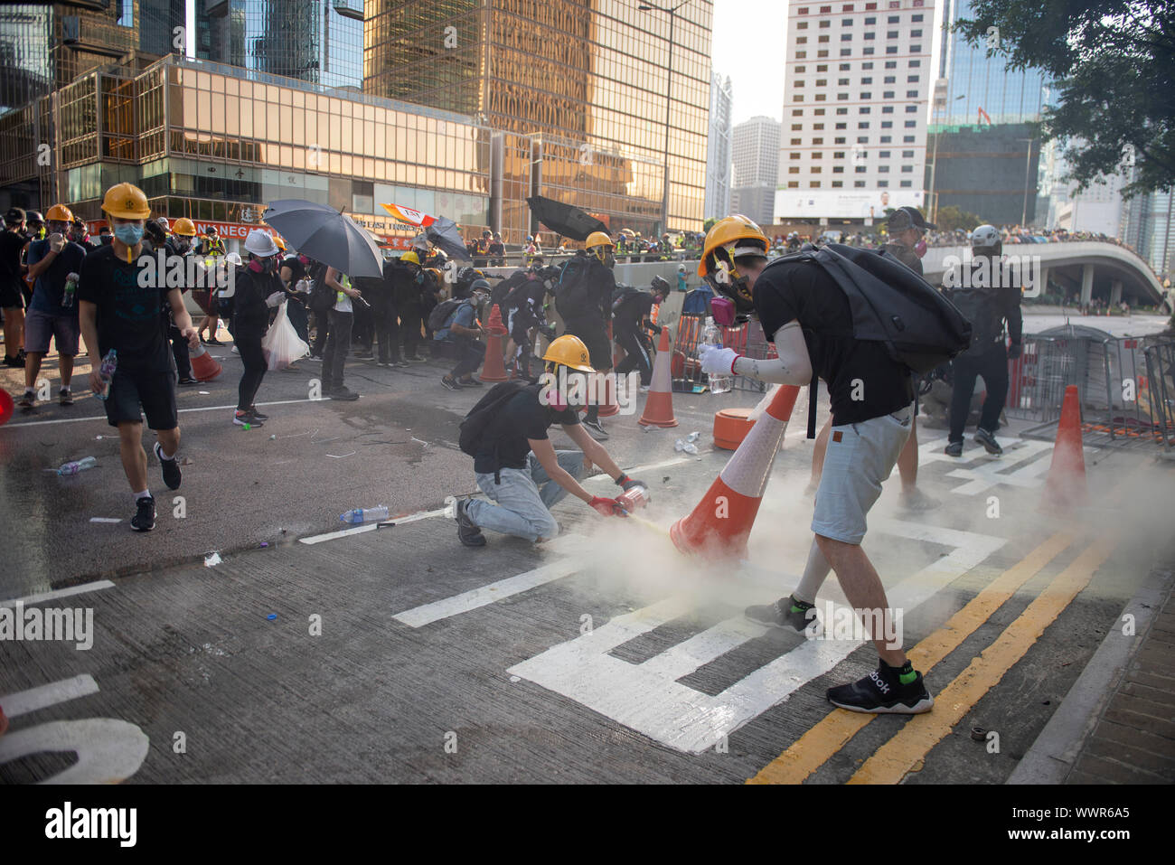 Protesters turning off tear gas bomb during protests Stock Photo