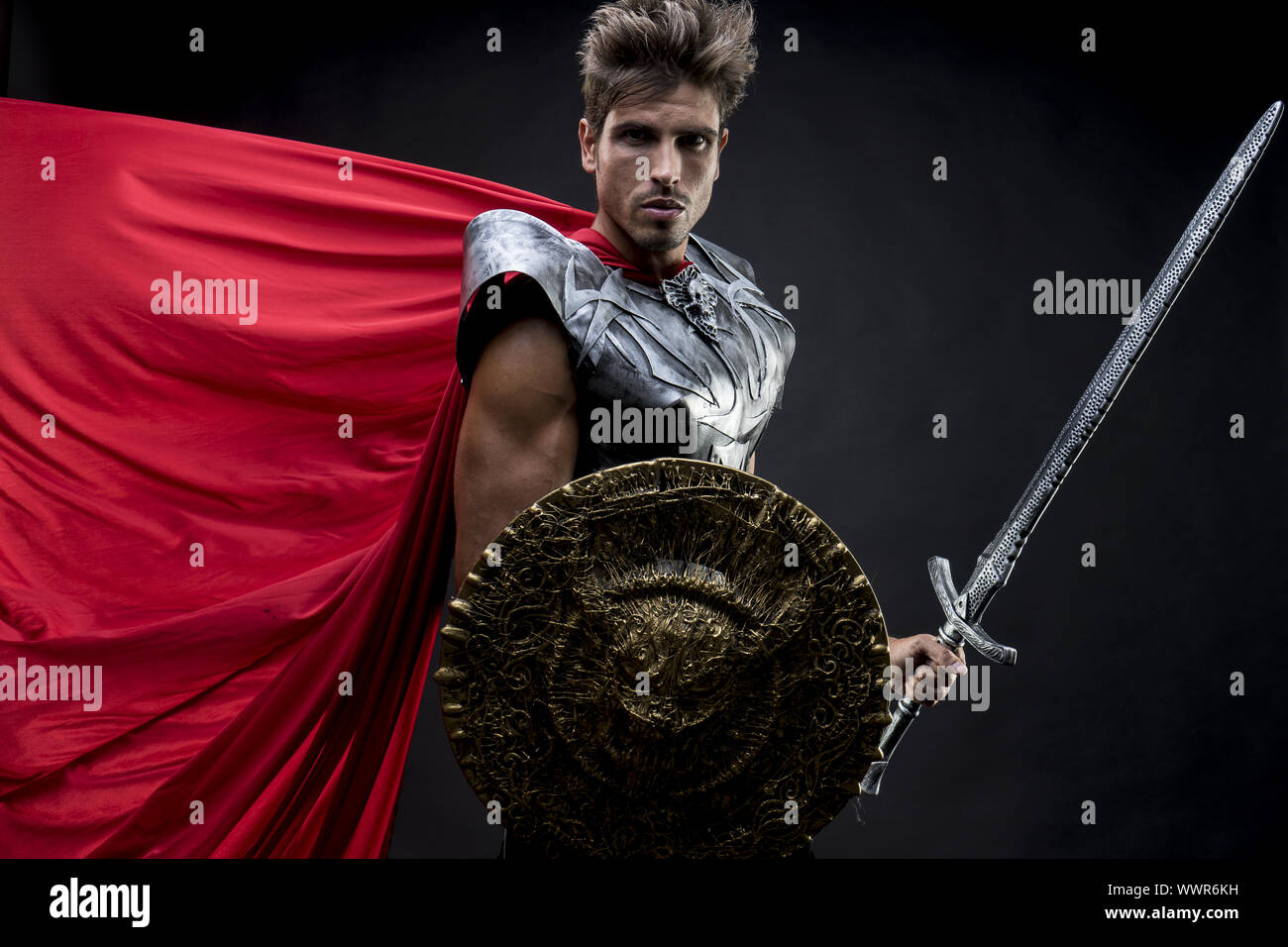 Power, centurion or Roman warrior with iron armor, military helmet with horsehair and sword Stock Photo