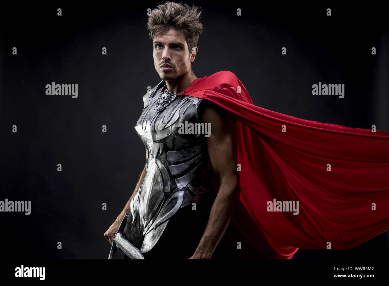 centurion or Roman warrior with iron armor, military helmet with horsehair and sword Stock Photo