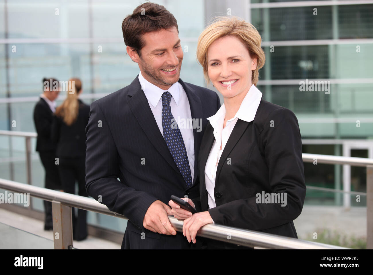 Business couple standing Stock Photo - Alamy