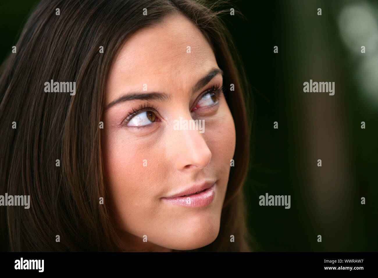 Portrait of a woman looking out of the corner of her eye Stock Photo