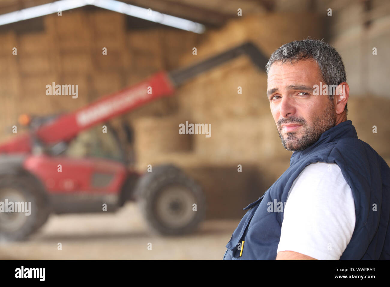 farmer posing in front of a tractor Stock Photo - Alamy