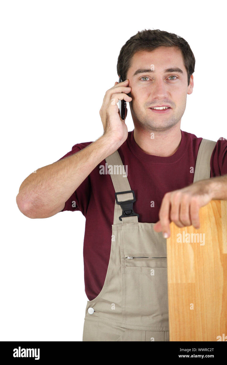 A carpenter talking on his mobile phone Stock Photo
