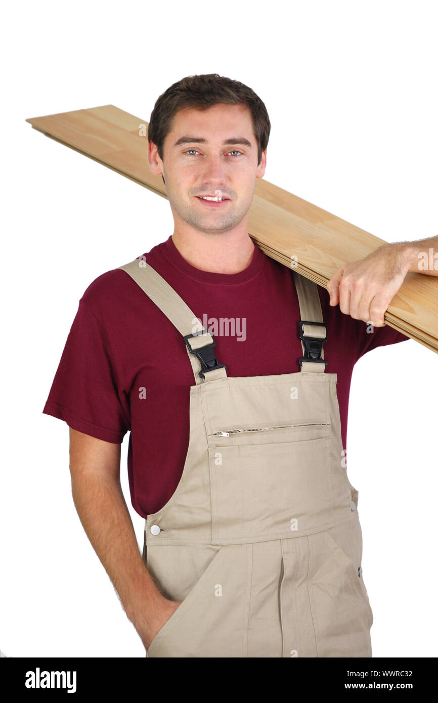 Carpenter carrying plywood Stock Photo