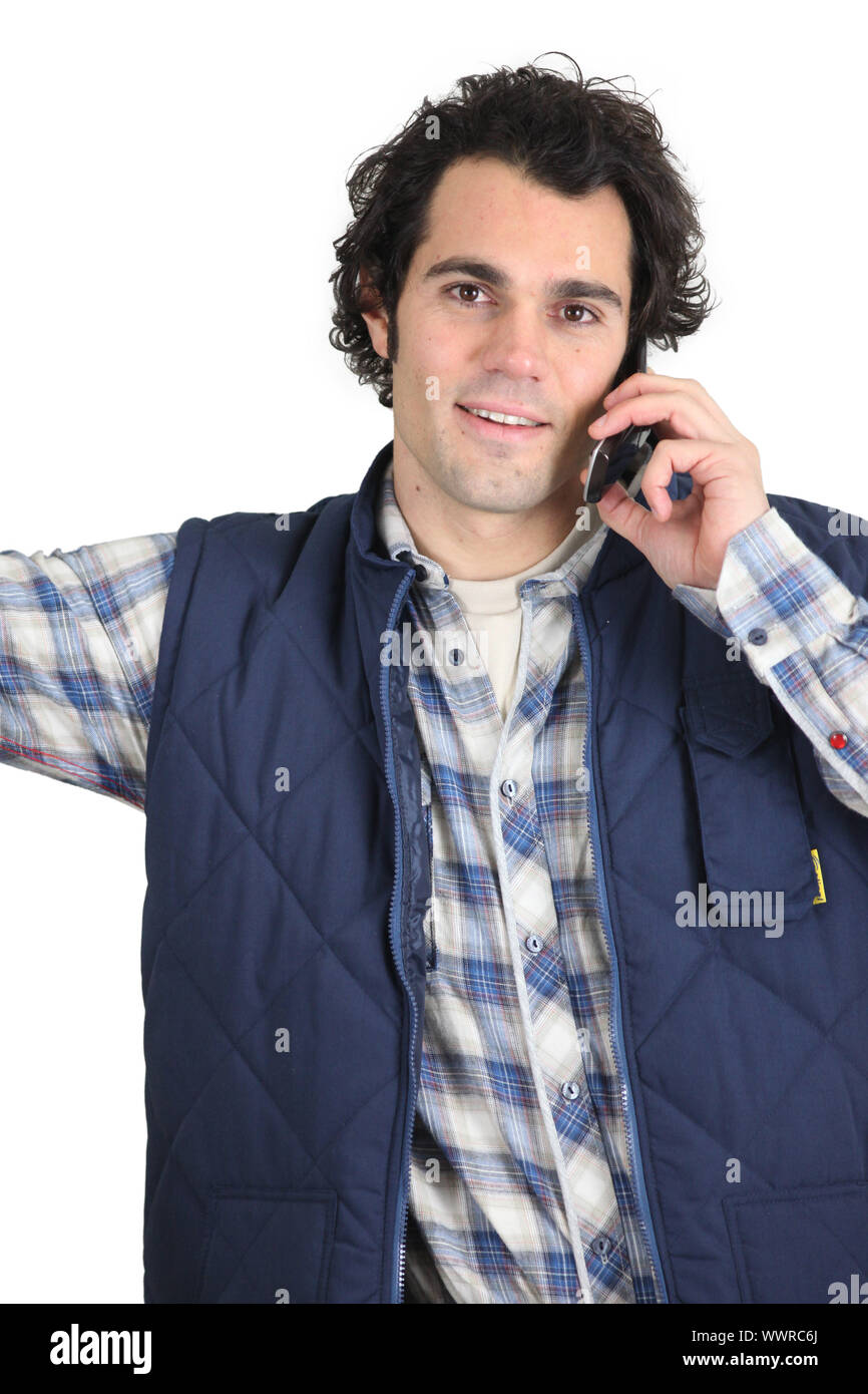 Workman using a cellphone Stock Photo