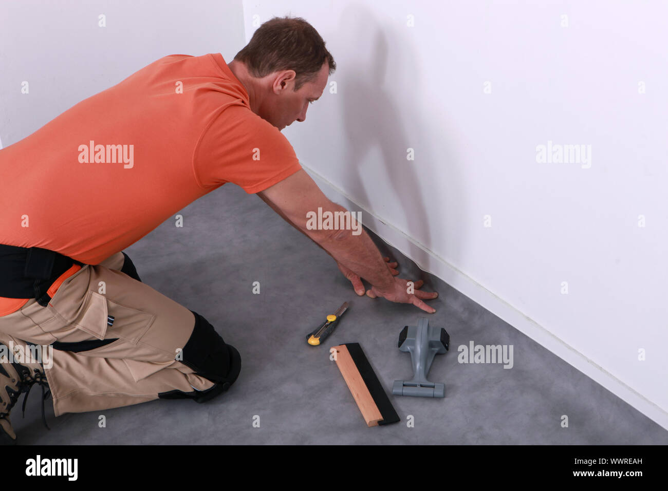 man installing linoleum Stock Photo
