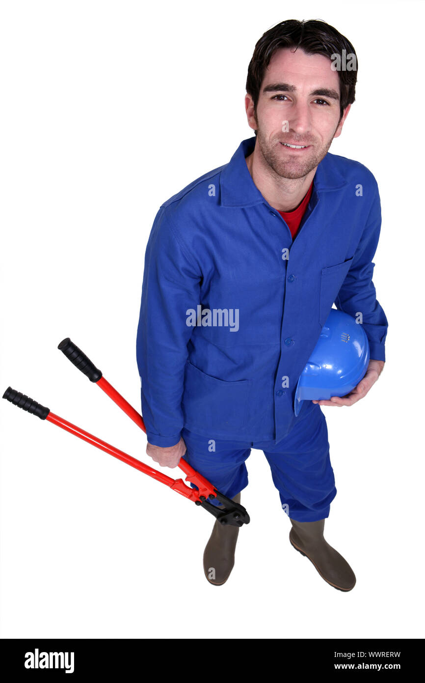 Worker wearing blue overalls Stock Photo